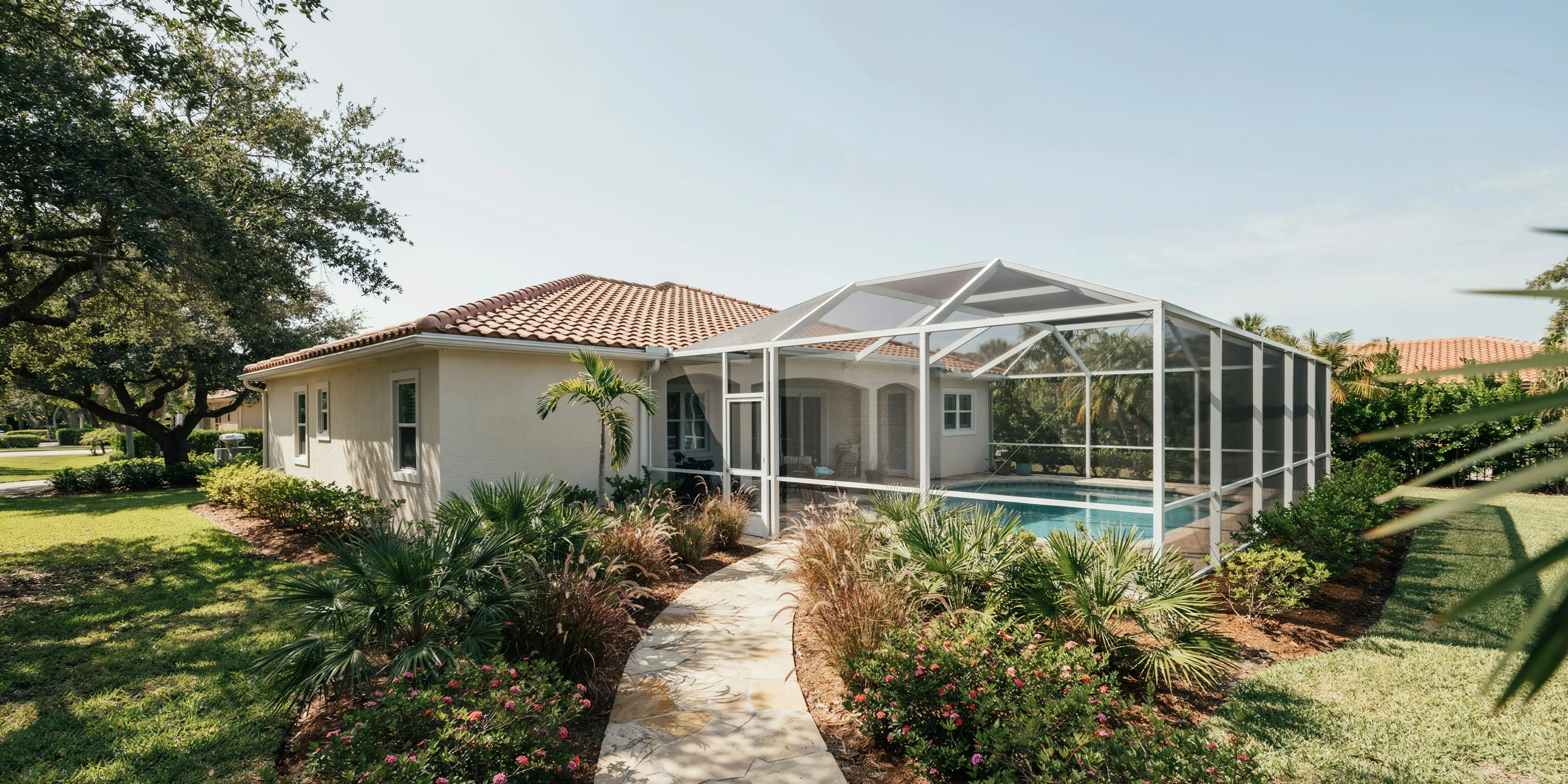 Classic stucco home with pool cage in Laurel Park, Sarasota, FL