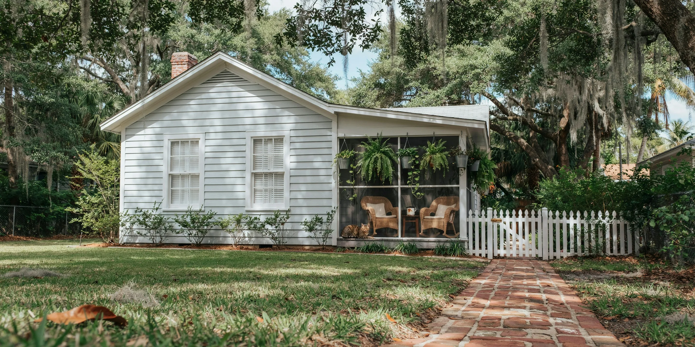 Bungalow with a deep screened porch under oaks in Newtown, Sarasota, FL