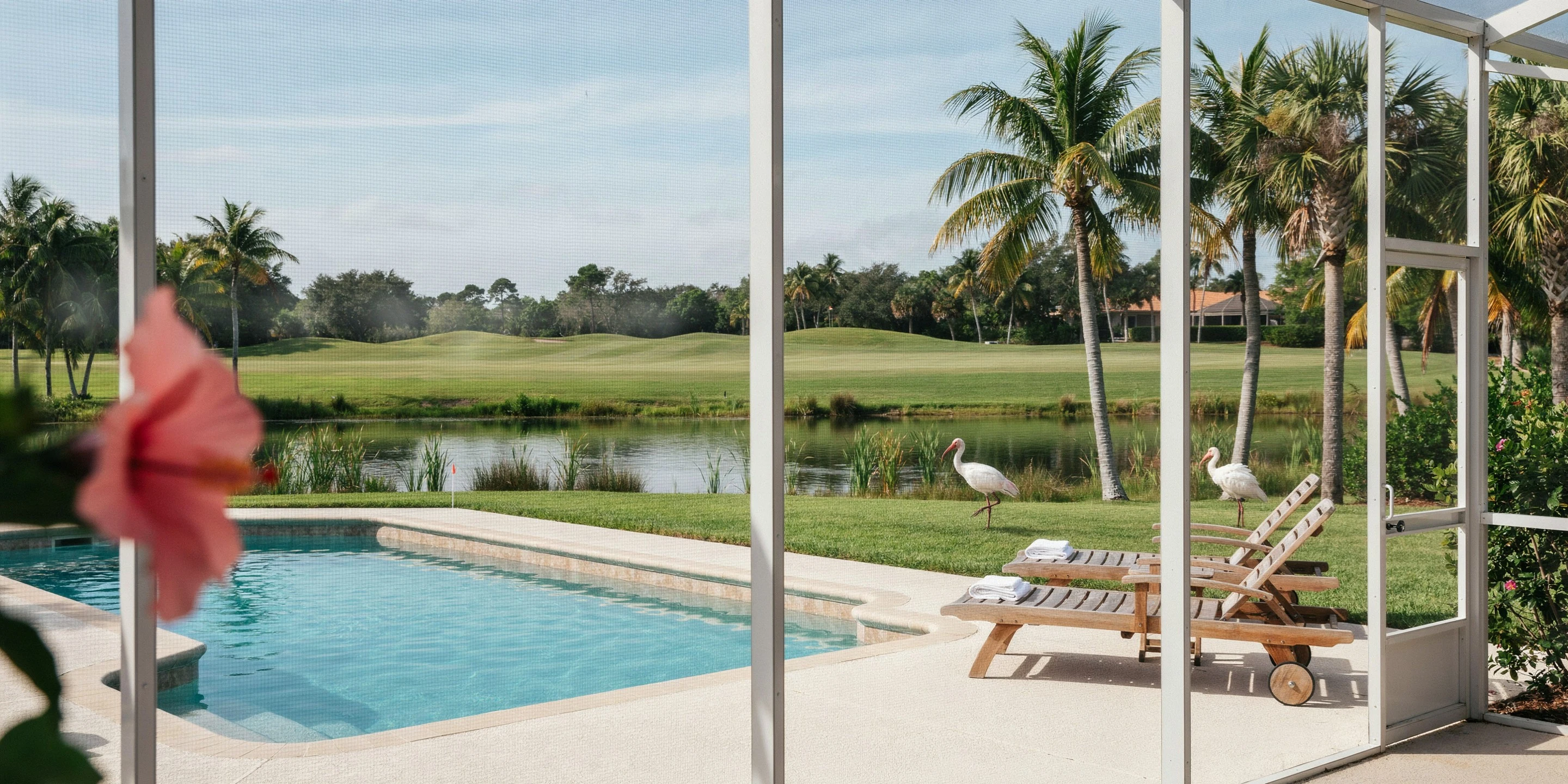 Golf villa with pool cage overlooking a fairway lake in Palmer Ranch, Sarasota, FL