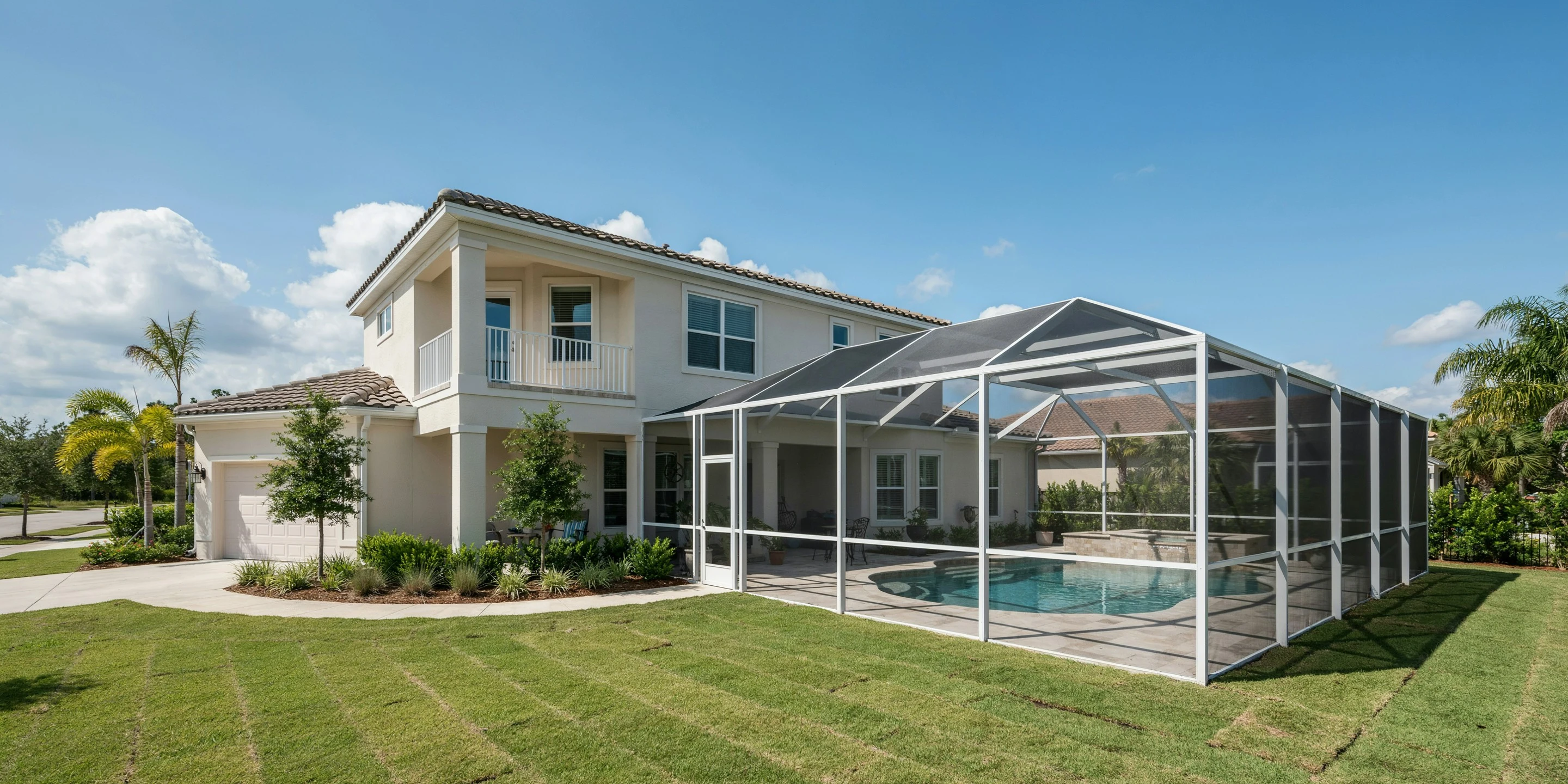 Newer two-story home with a tall pool cage near the Rosemary District, Sarasota, FL