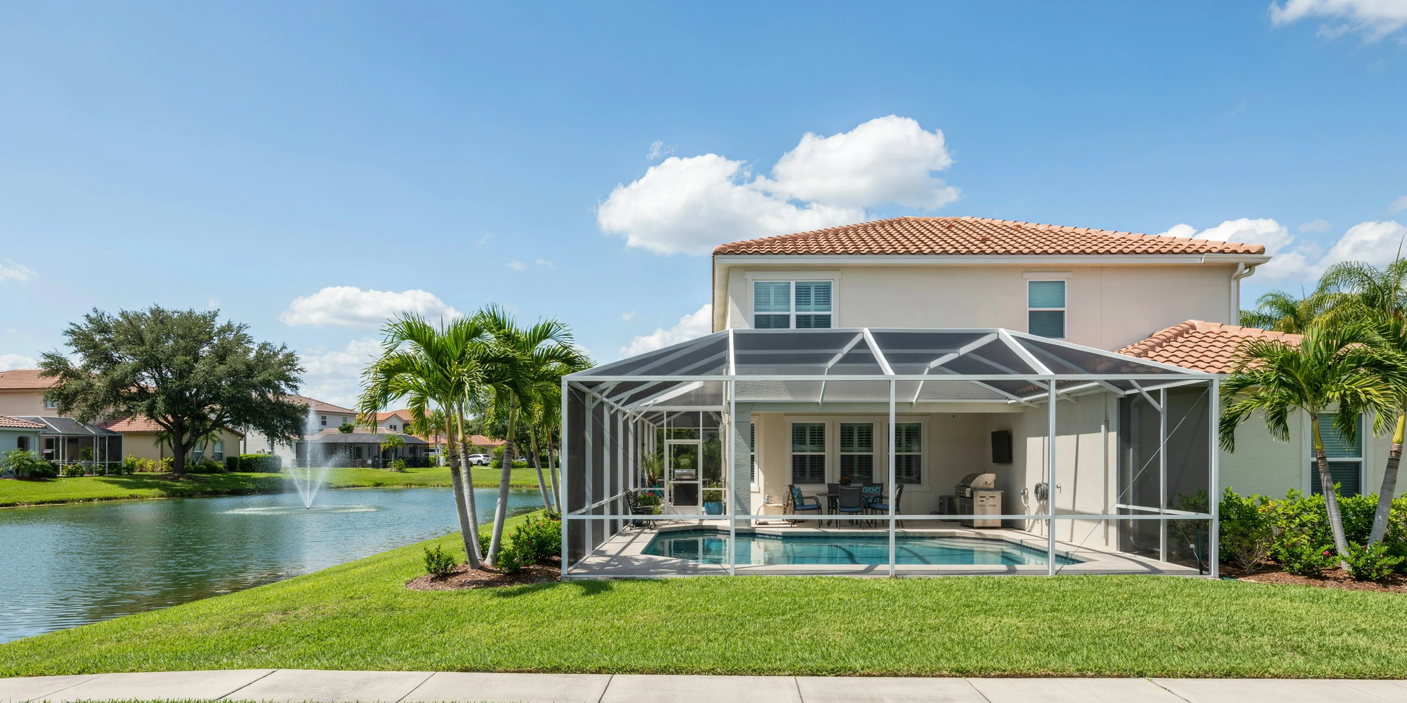 Home with pool cage beside a lake in South Gate, Sarasota, FL